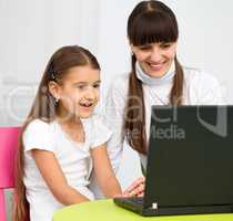 Mother an her daughter with laptop