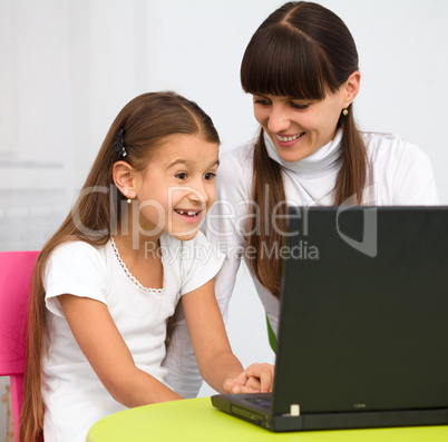 Mother an her daughter with laptop