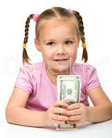 Cute little girl with paper money - dollars