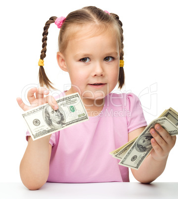 Little girl is counting dollars