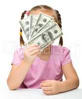 Cute little girl with paper money - dollars