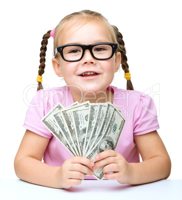 Little girl is counting dollars