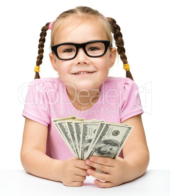 Little girl is counting dollars