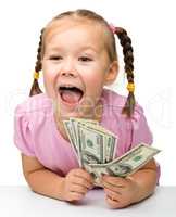 Cute little girl with paper money - dollars