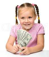 Cute little girl with paper money - dollars