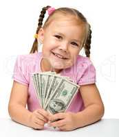 Cute little girl with paper money - dollars