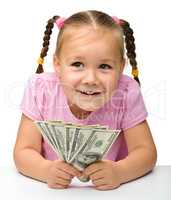 Cute little girl with paper money - dollars