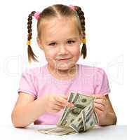 Cute little girl with paper money - dollars