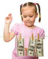 Cute little girl with paper money - dollars