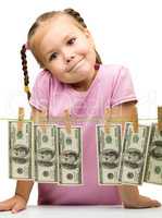 Cute little girl with paper money - dollars