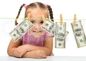 Cute little girl with paper money - dollars