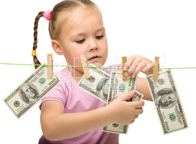 Cute little girl with paper money