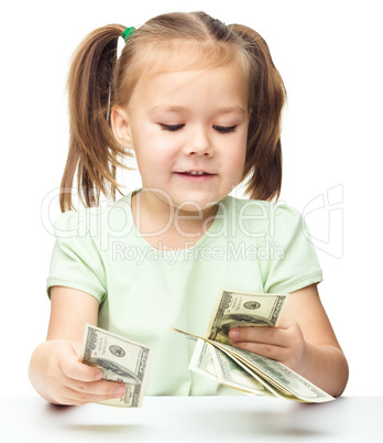 Little girl is counting dollars