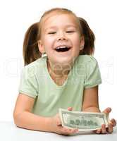 Cute little girl with paper money - dollars