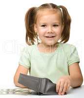 Cute little girl with paper money - dollars