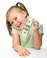 Cute little girl with paper money - dollars