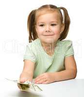 Cute little girl with paper money - dollars