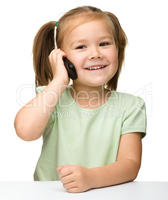 Cute little girl is talking on cell phone