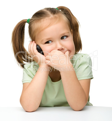 Cute little girl is talking on a cell phone