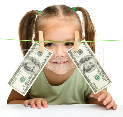 Cute little girl with paper money - dollars