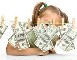 Cute little girl with paper money - dollars