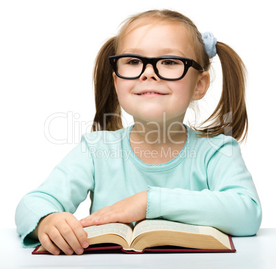 Happy little girl with book wearing black glasses