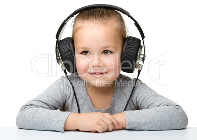 Cute girl enjoying music using headphones