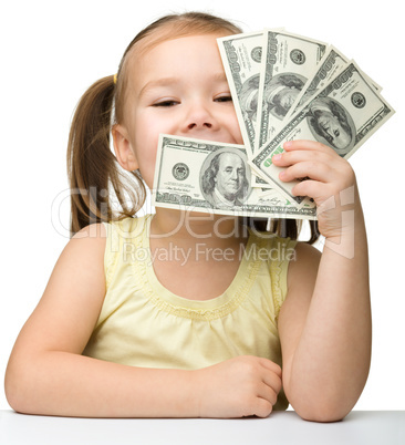 Cute little girl with paper money - dollars