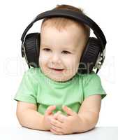 Cute boy enjoying music using headphones