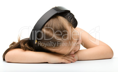 Cute little girl is sleeping in headphones