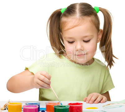 Cute cheerful child play with paints