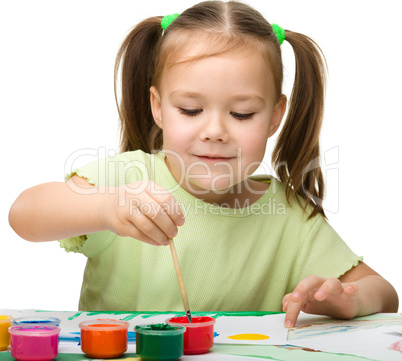 Cute cheerful child play with paints