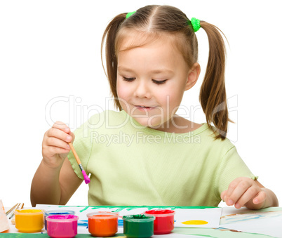 Cute cheerful child play with paints