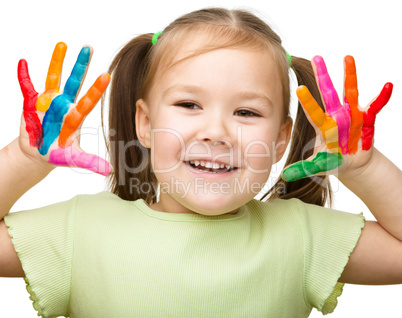 Portrait of a cute girl playing with paints