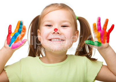 Portrait of a cute girl playing with paints