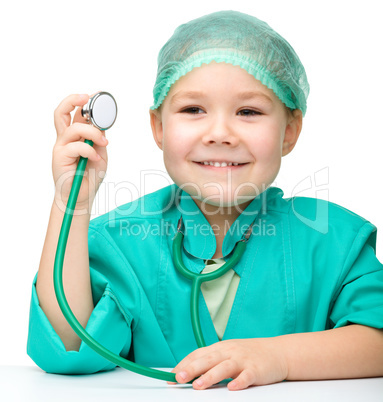 Cute little girl is playing doctor