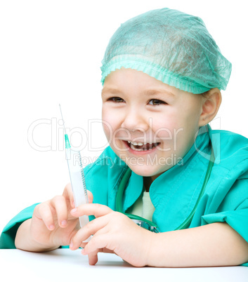 Cute little girl is playing doctor with syringe