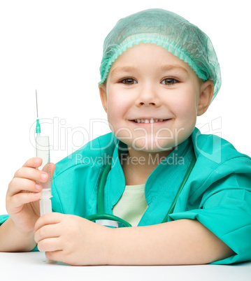 Cute little girl is playing doctor with syringe