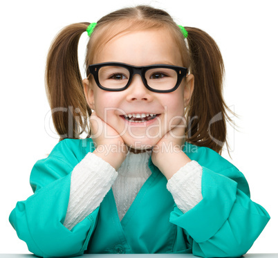 Cute little girl is playing doctor