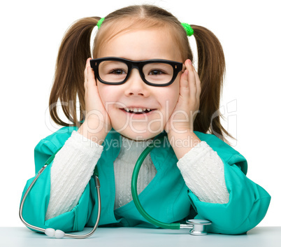 Little girl is playing doctor with stethoscope