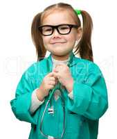 Cute little girl is playing doctor