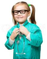 Cute little girl is playing doctor