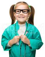 Cute little girl is playing doctor