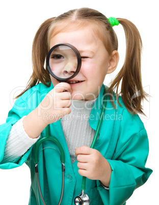 Cute little girl is playing doctor