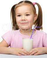 Cute little girl with a glass of milk