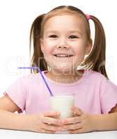 Cute little girl with a glass of milk