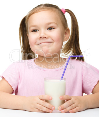 Cute little girl with a glass of milk