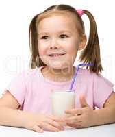 Cute little girl with a glass of milk