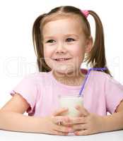 Cute little girl with a glass of milk