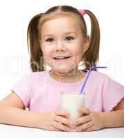 Cute little girl with a glass of milk